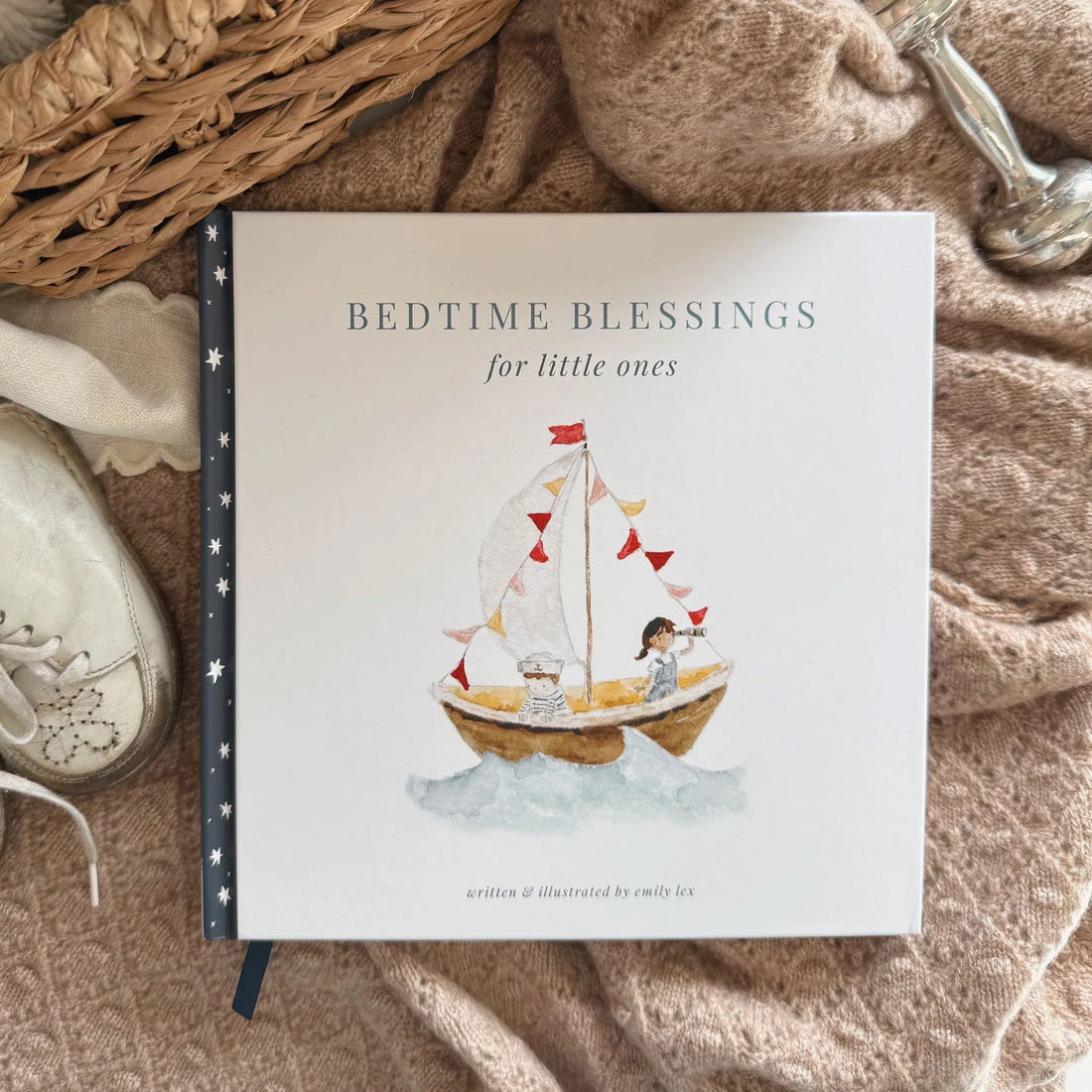 Book titled 'Bedtime Blessings for little ones' with a sailboat illustration on a textured surface.