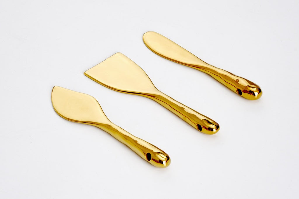 Three cheese knives on a white background