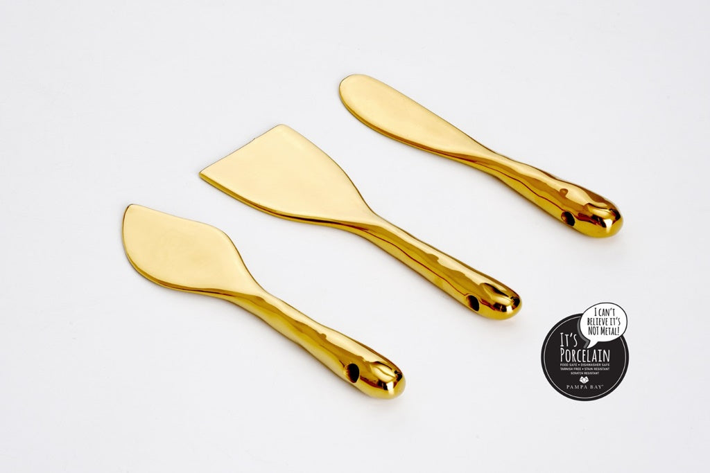Three gold cheese knives on a white background with a brand logo in the corner.
