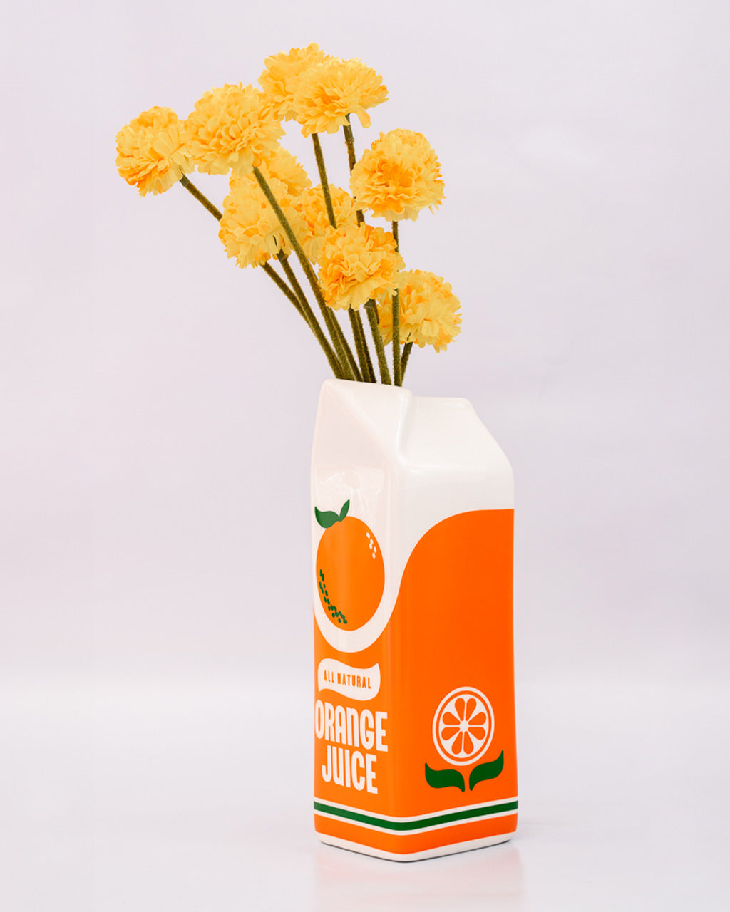 Orange juice carton design vase with yellow flowers on a white background