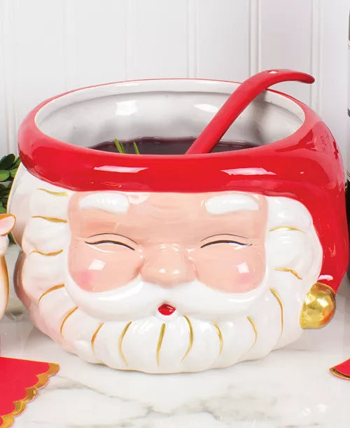 Seasonal - Home Decor- Santa Punch Bowl - red hat and red  ladle.  Evergreen branch behind product.  Punch bowl filled with red liquid. 