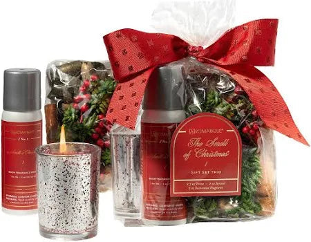 Seasonal - Smell of Christmas Gift Set showing candle, spray and potpourri that make up the set.  Tied in a clear bag with a red bow.  
