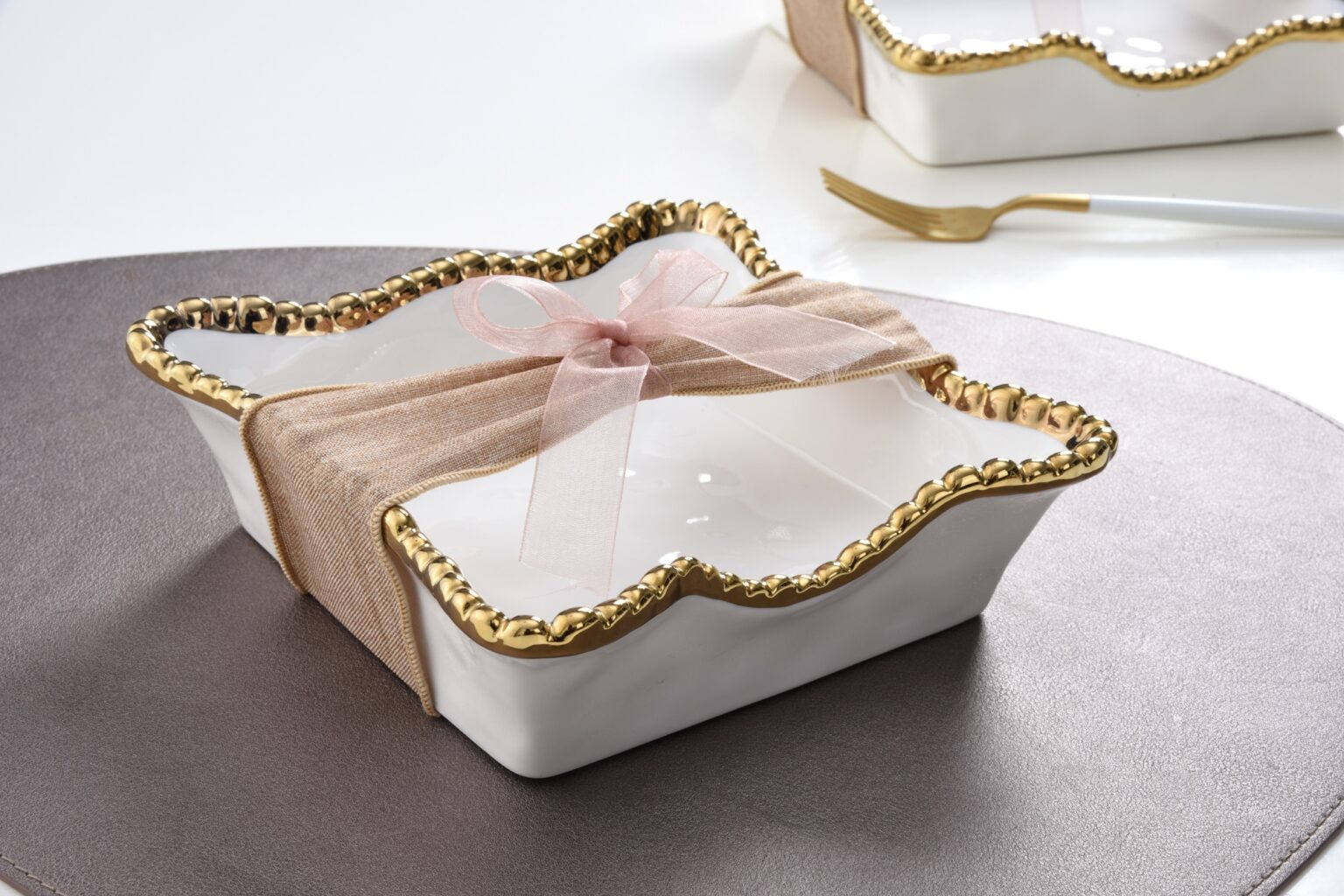 Napkin Holder - Cocktail - White with Gold Beads-white na-kin holder with gold beaded edges is pictured on a brown round table with a pink and brown bow tied around it