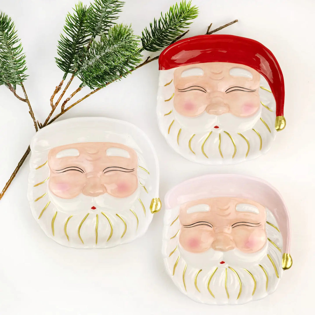 Seasonal - Plate - Dessert - Santa - Red hat with gold details.  White background.  Also shows 2 other varieties of plate - pink and ivory.  
