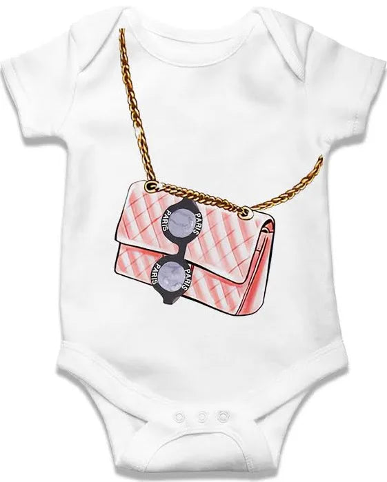 White baby onesie with a pink handbag and sunglasses design on a white background