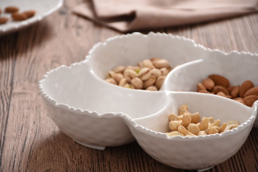 Pampa Bay 4-Section Bowl Melamine White on a light gray background with nuts on a wooden surface