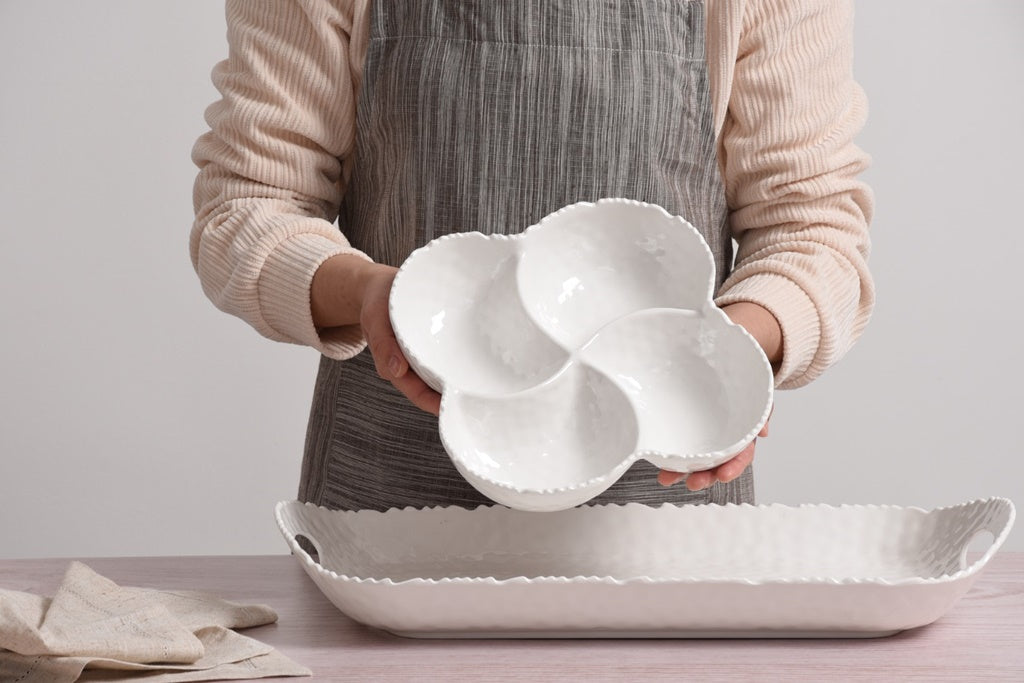 Person holding a Pampa Bay 4-Section Bowl Melamine White on a light gray background with a unique design on a neutral background