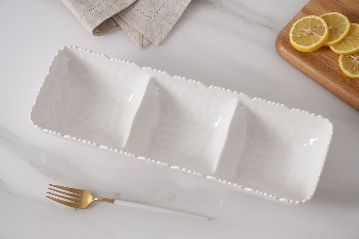 Pampa Bay 3-Section Melamine Serving Platter, White on a light gray background And marble surface with a gold fork and lemon slices.