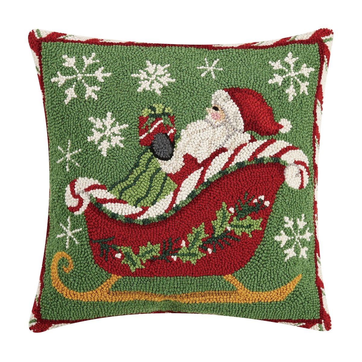Decorative pillow with a festive design of Santa Claus in a sleigh, surrounded by snowflakes on a green background.