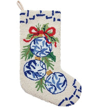 Decorative Christmas stocking with blue ornaments and greenery on a white background