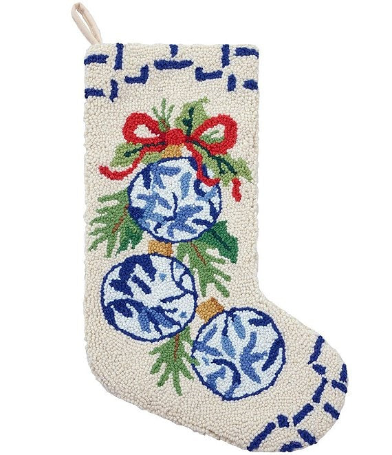Decorative Christmas stocking with blue ornaments and greenery on a white background