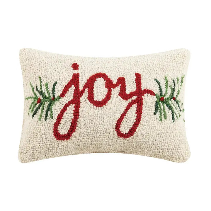 Decorative pillow with 'joy' text and Christmas elements on a white background