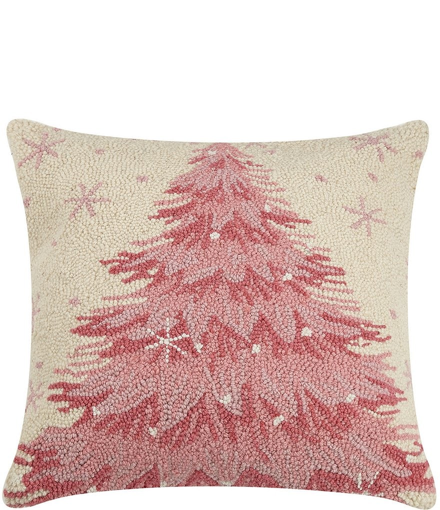 Decorative pillow with pink Christmas tree design on a beige background