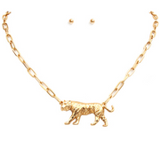 Gold necklace with a tiger pendant and matching earrings on a white background