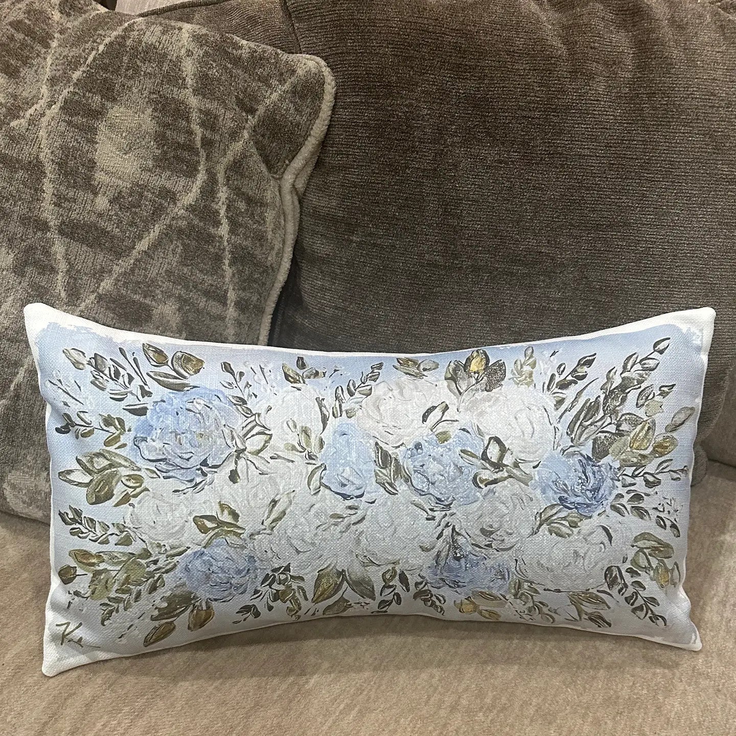 Southern Cotton Mill Floral hydrangea patterned pillow on a brown couch