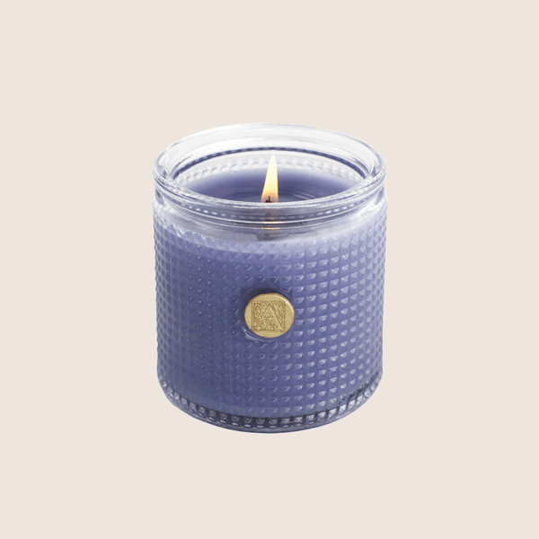 AromatiqueLavender Bouquet Candle 6 oz Blue textured candle with a gold emblem on a beige background 