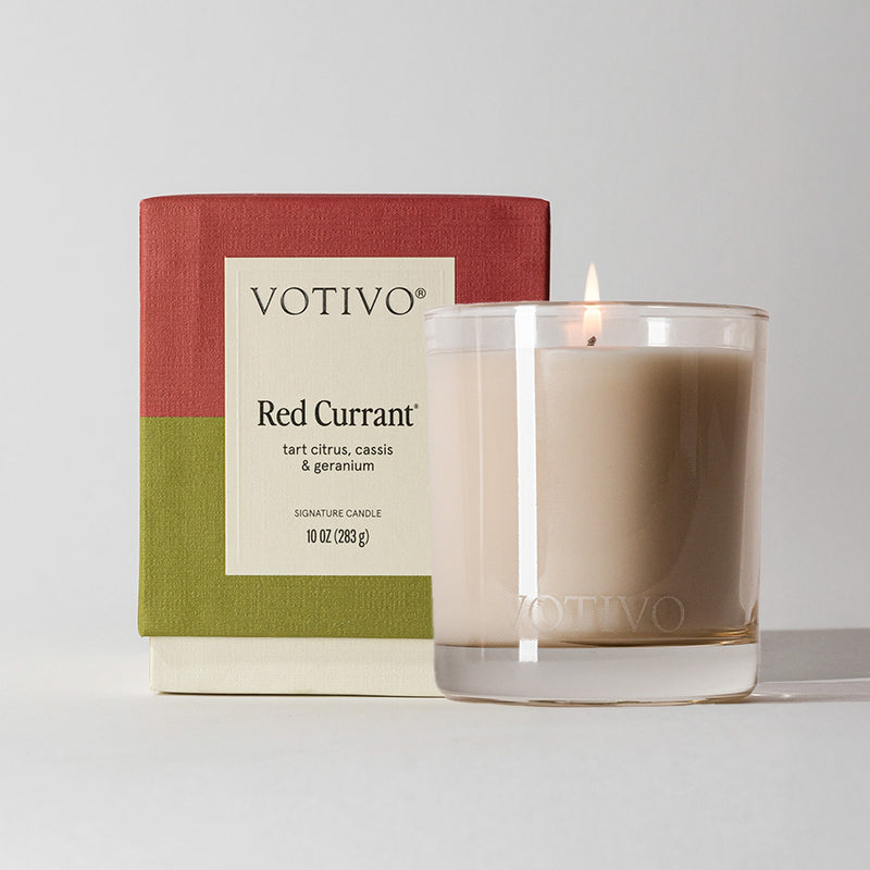 Votivo Red Currant candle with packaging on a light gray background