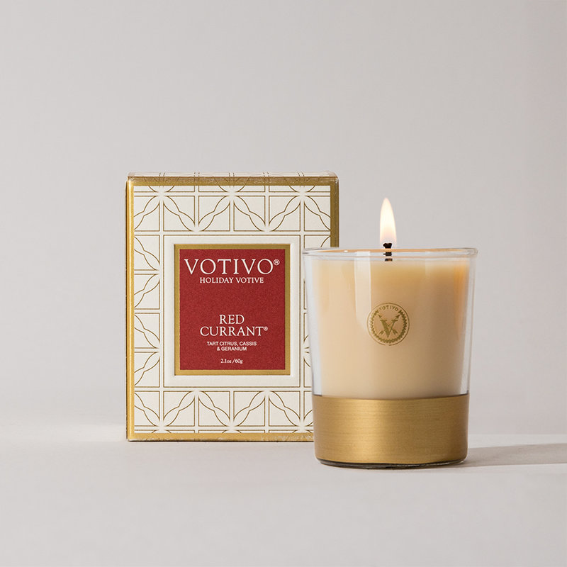 Votivo Red Currant candle with a matching box on a light gray background