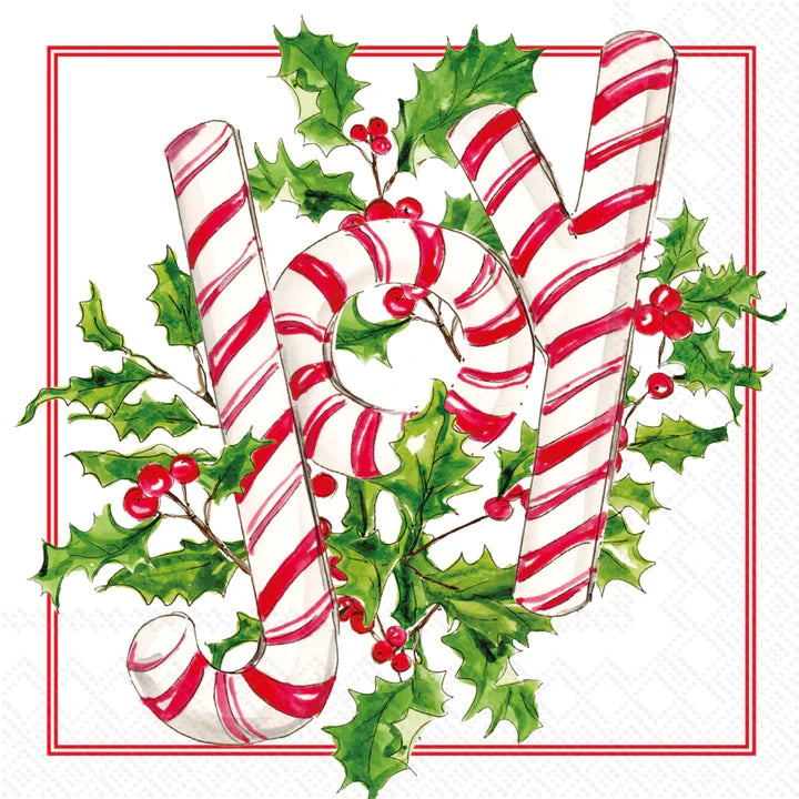 Candy canes and holly leaves with berries on a white background