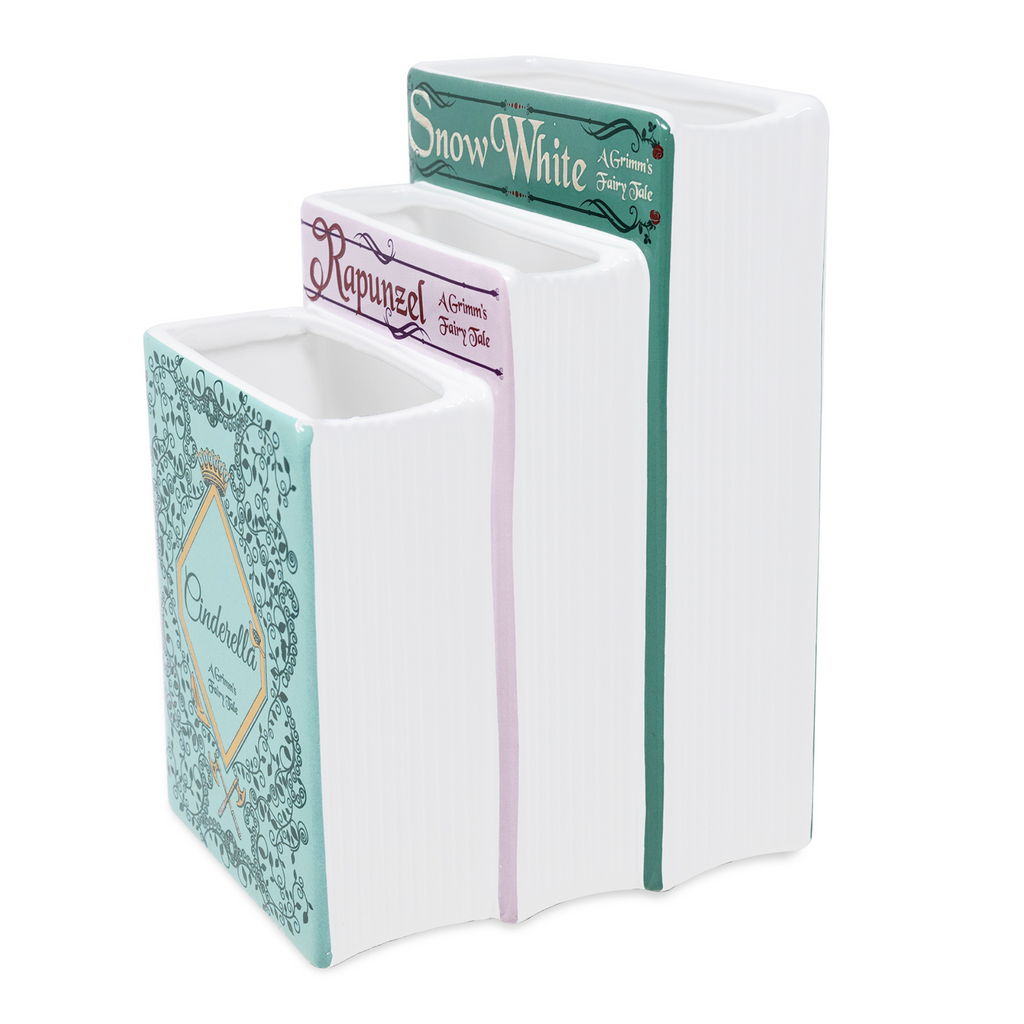 Three book-shaped containers with 'Snow White', 'Rapunzel', and 'Cinderella' labels on a white background.