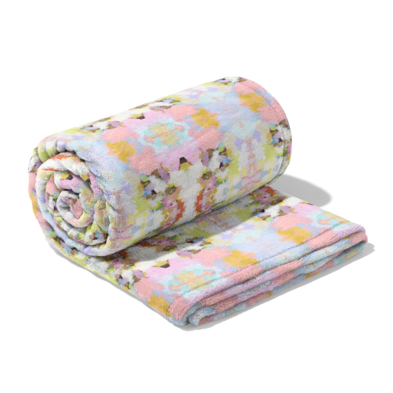 Floral-patterned quilt rolled up on a white background