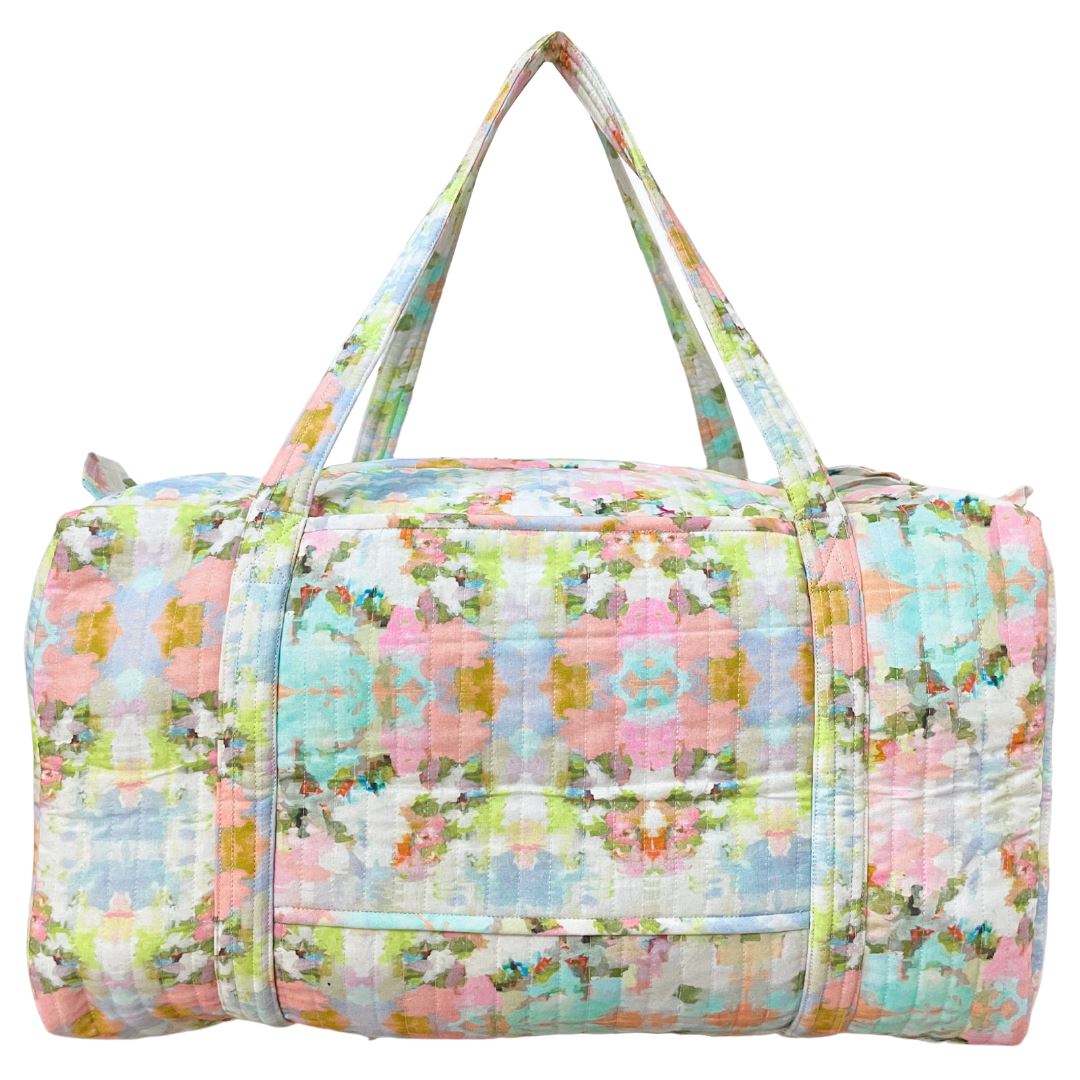 Floral patterned duffel bag on a white background