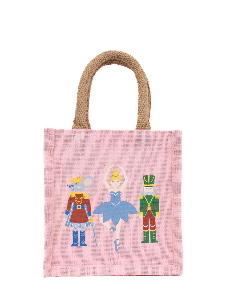 Pink tote bag with fairy tale character illustrations on a white background