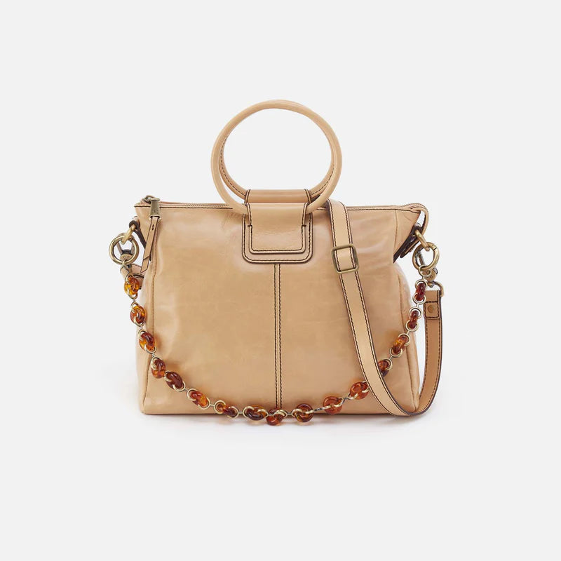 Beige handbag with a beaded strap on a white background