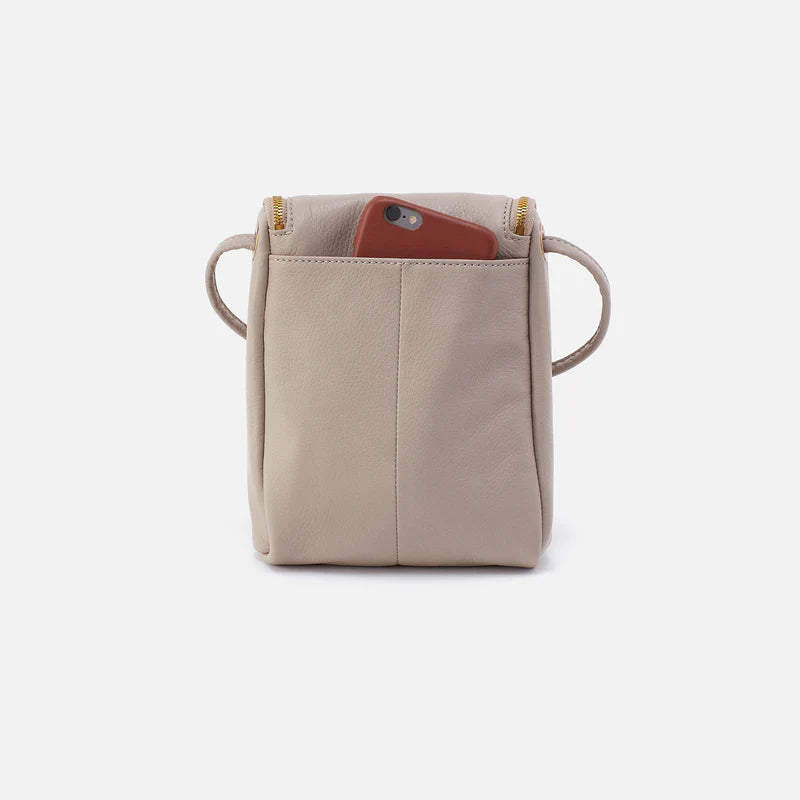 Beige crossbody bag with a phone inside on a white background