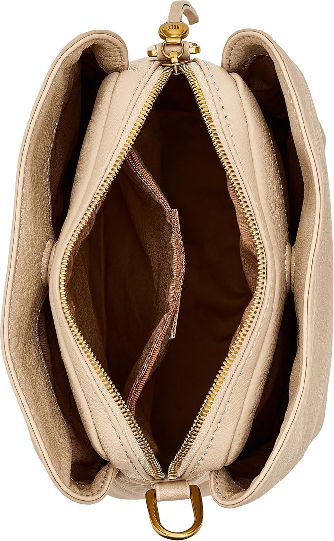 Beige handbag with gold zipper and hardware on a white background