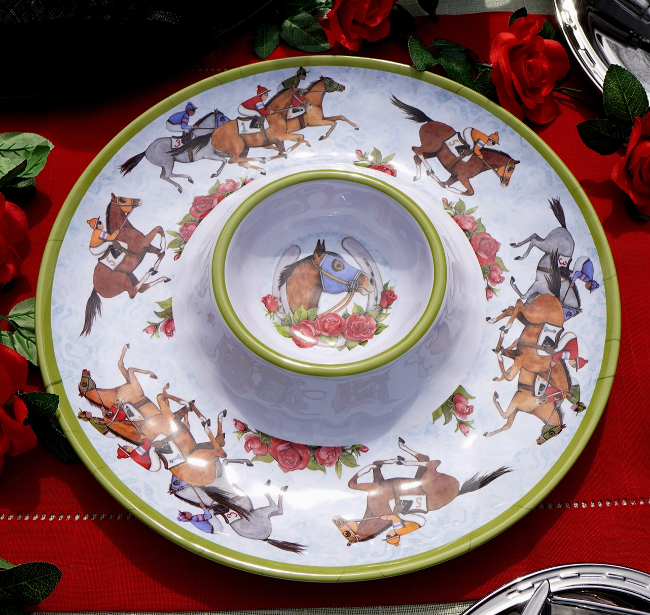 Decorative melamine chip and dip  plate with horse illustrations on a red  set table with red tablecloth and red roses.