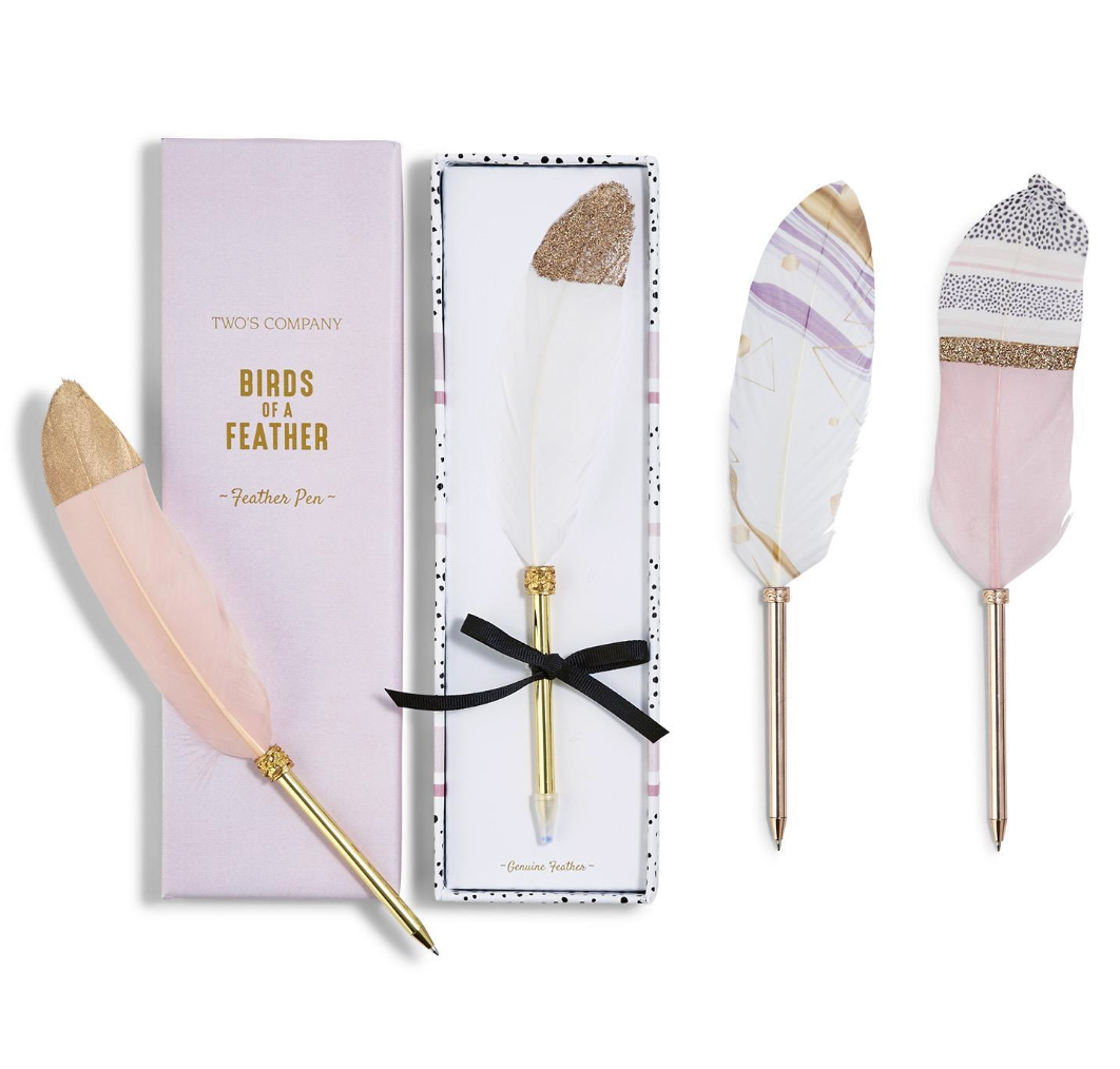 Decorative pink, white and gold feather with gold stylus pen set with packaging on a white background