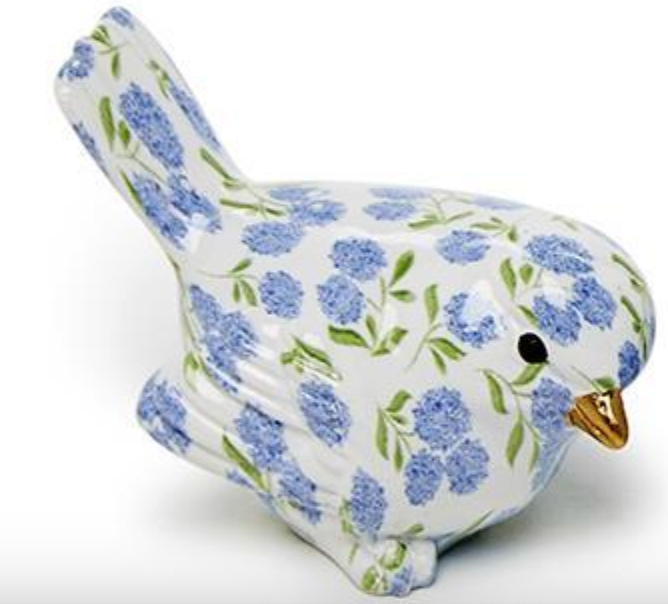 Ceramic bird with blue floral pattern and gold beak with black eyes on a white background
