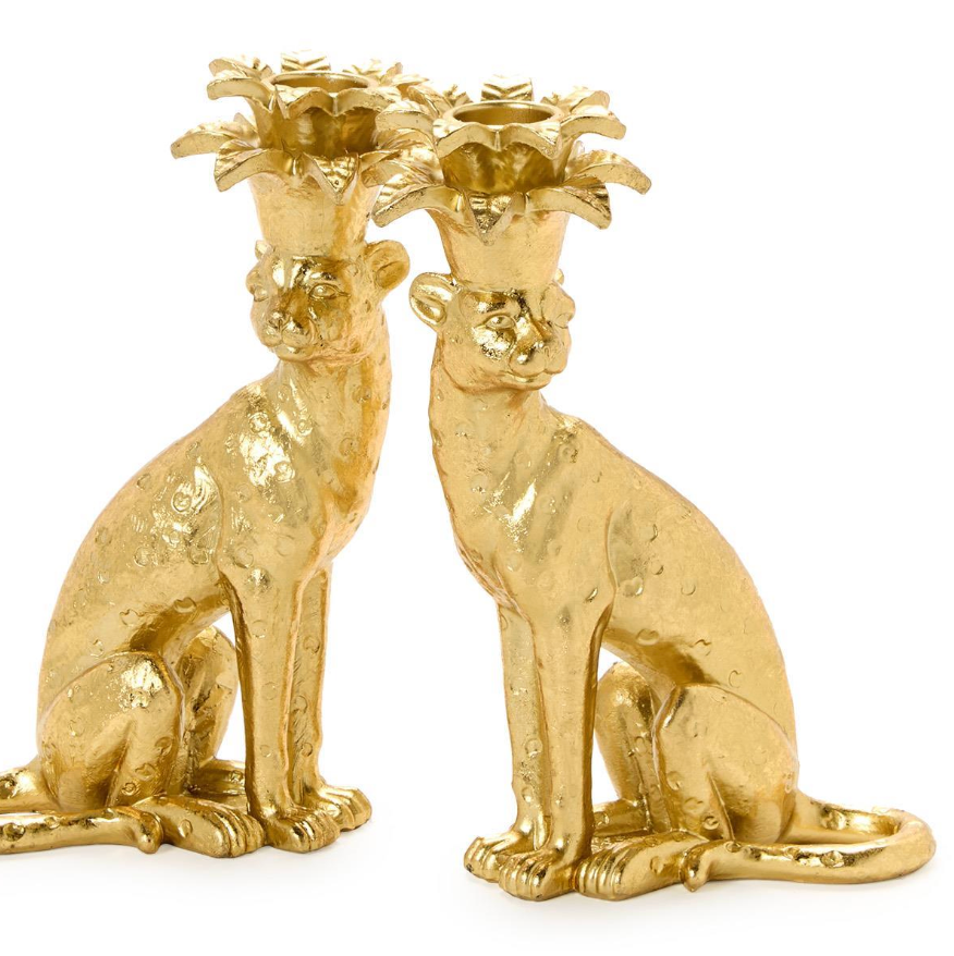 Gold leopard candle holders on a white background