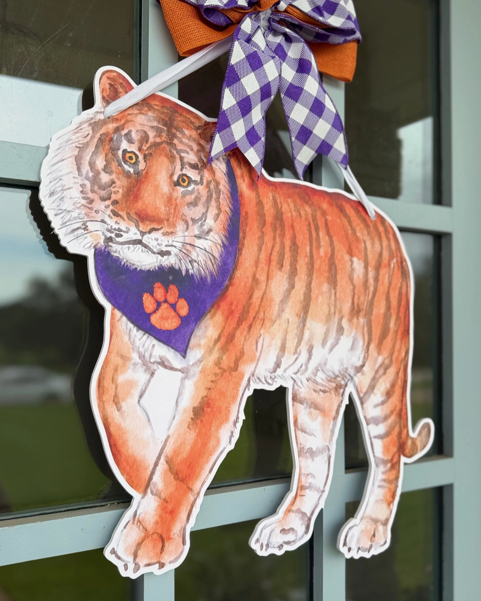 Orange tiger door hanger with pirple scarf on glass door