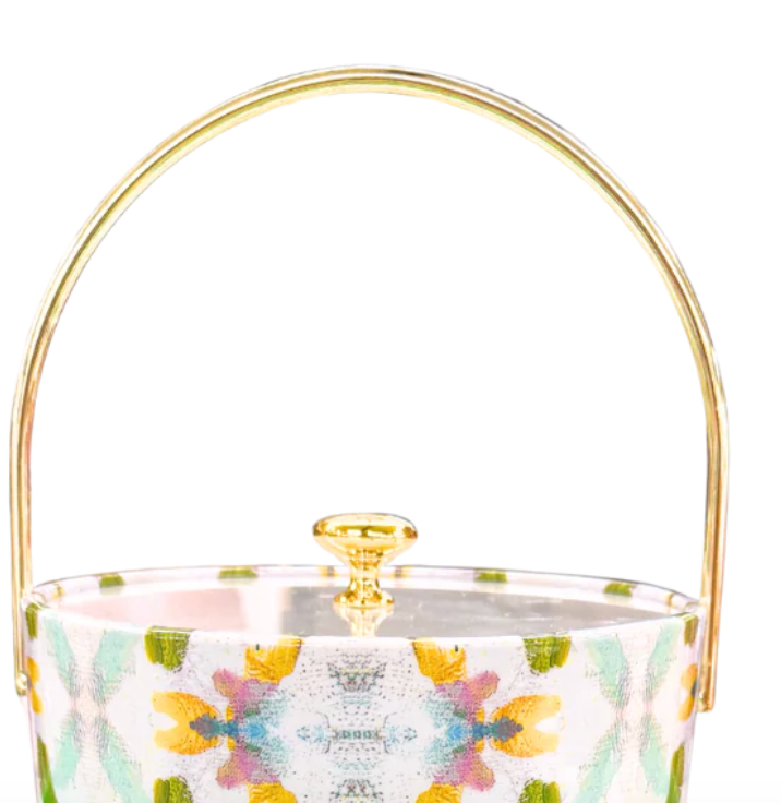 Top of ice bucket with floral pattern and gold handle on a white background