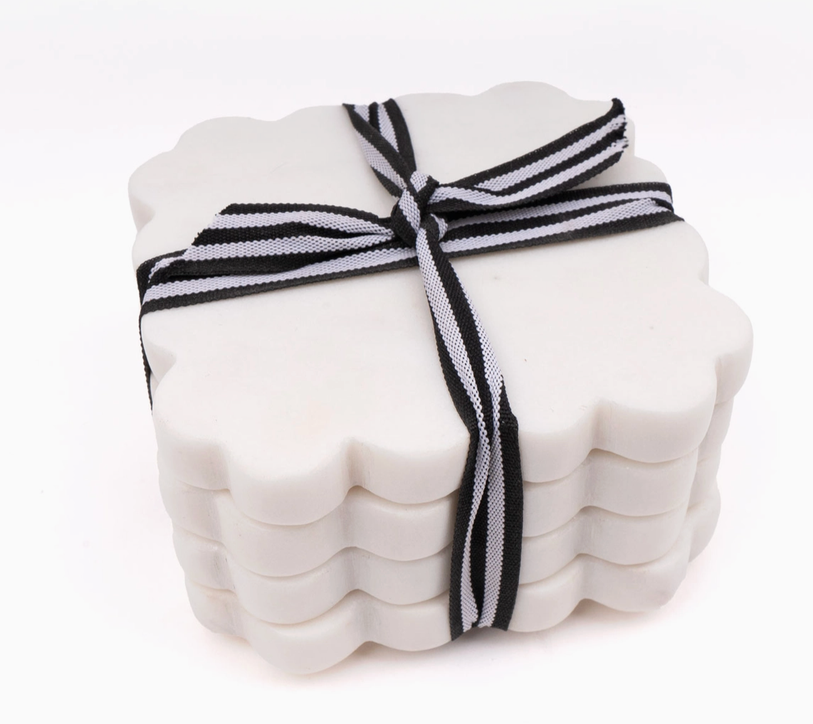 8 Oak Lane brand White  marble scalloped coasters with a black and white striped ribbon on a white background