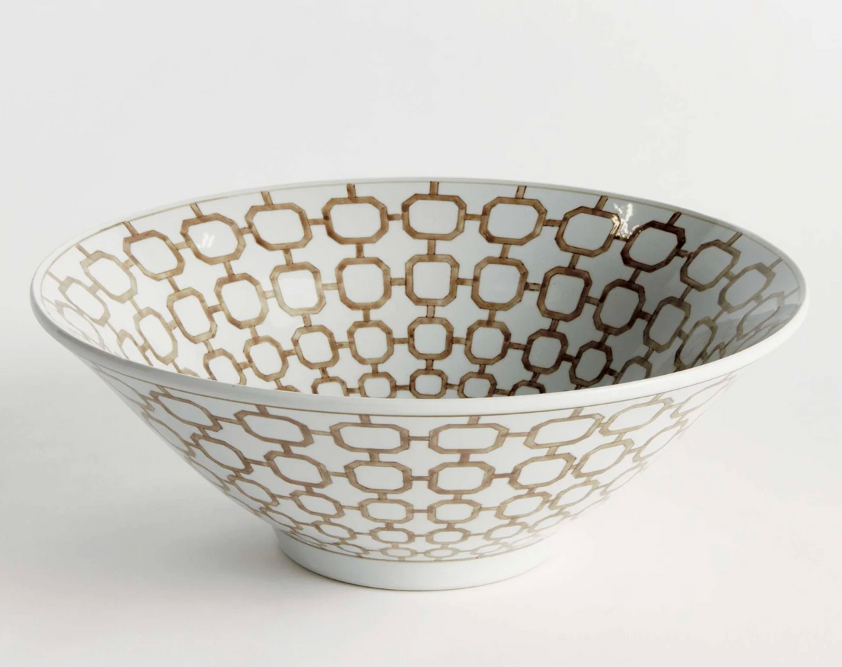 A Napa brand white ceramic bowl with an elegant brown geometric trellis pattern, photographed on a seamless light gray background.