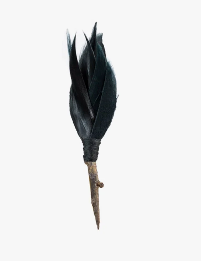 Brackish brand lapel pin in black feathers on white background