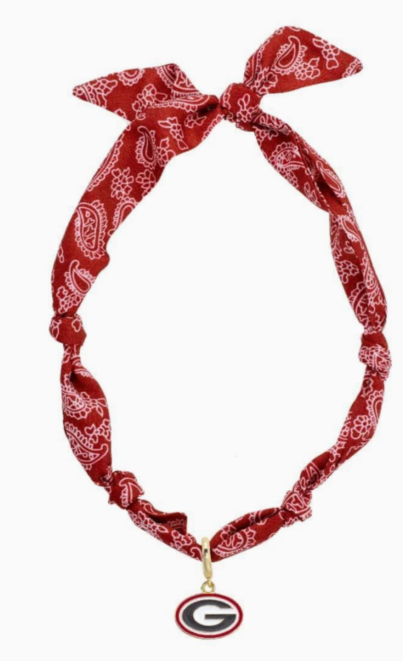 A canvas brand Georgia Bulldogs charm necklace with a red and white paisley bandana, knotted details, tied bow, and oval G logo pendant.