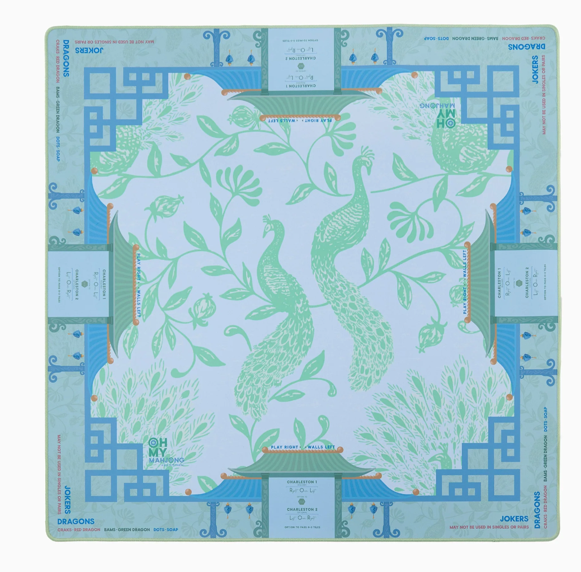 Oh My Mahjong Isla mat with green peacocks, leafy vines, blue geometric borders, and printed game reminders