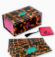 Oh My Mahjong Glow Wild tortoiseshell-pattern box with a pink zippered pouch and matching instructional cards.
