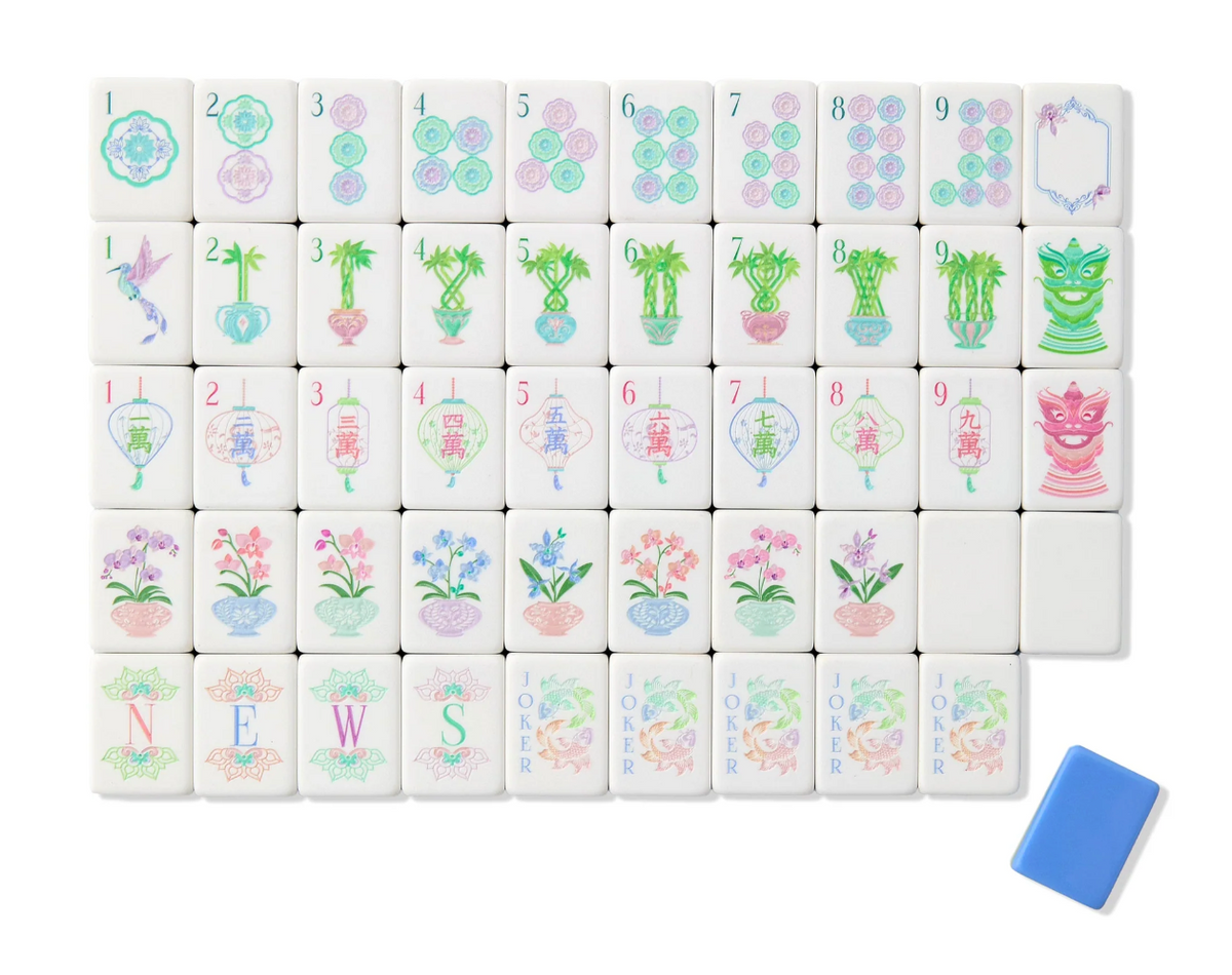 Oh My Mahjong Moonlight tiles with pastel dots, potted bamboo, lanterns, orchids, and floral Jokers beside a blue tile back.