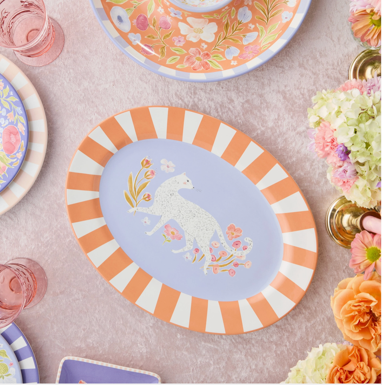 Decorative plate with unicorn design on a table with floral elements