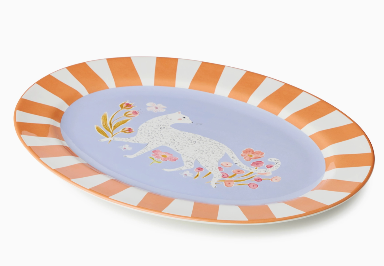 Decorative plate with a unicorn design and striped border on a white background