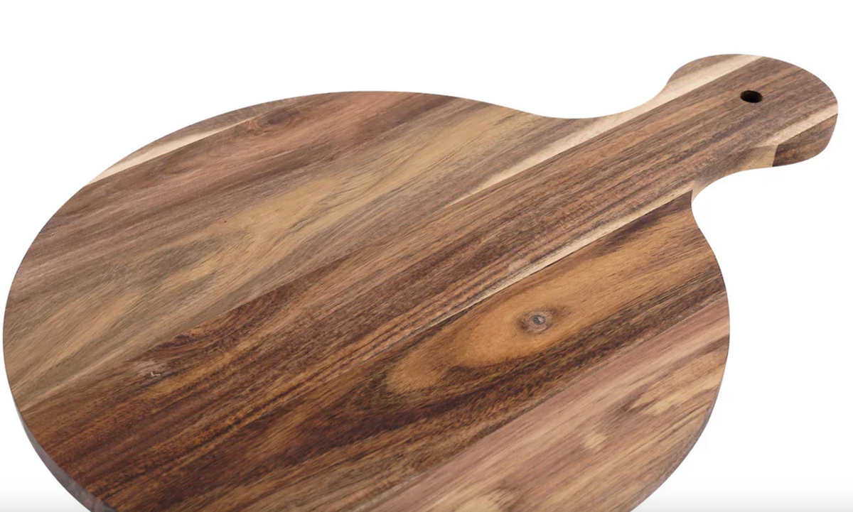Wooden round charcuterie and serving board with a handle that has hole for a peg to add a topper for decorative addition. shown on a white background
