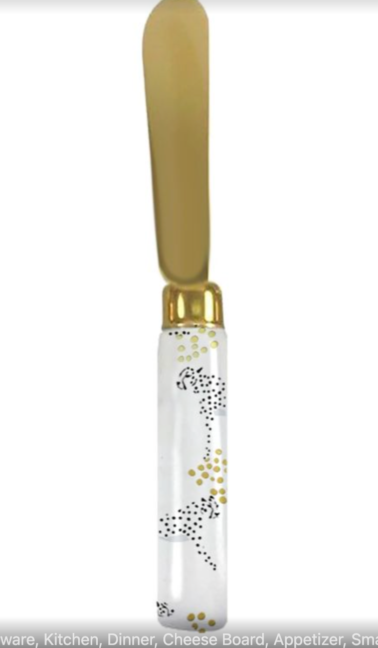 Knife with cheetah printed black and gold ceramic handle and decorative gold blade on a white background