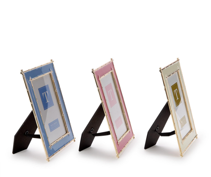 Three picture frames  for a 4 x 6" picture , Enamel with gold bamboo edges photo frames on stands one blue, one pink, one white on a white background