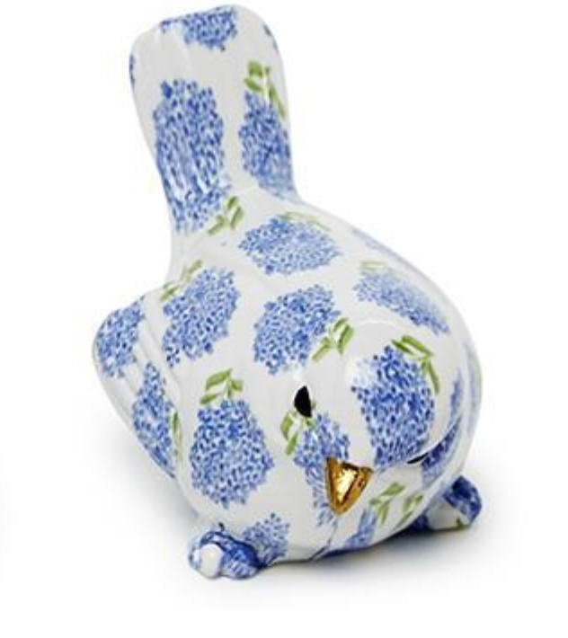 Ceramic bird figurine with blue floral pattern on a white background