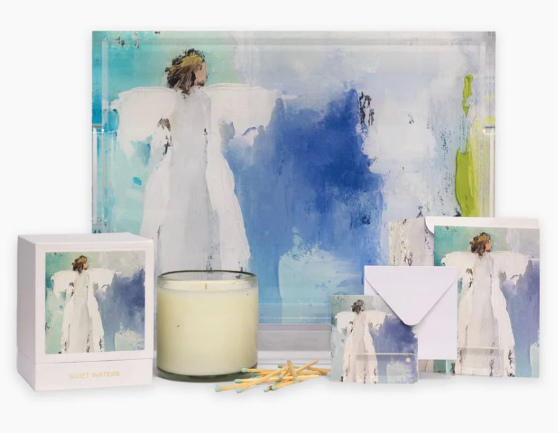 Decorative set with angel figurines, a candle, and cards  and acrylic tray standing on its side with abstract angel in white on blue, green and turquoise weatercolor tray. White background.